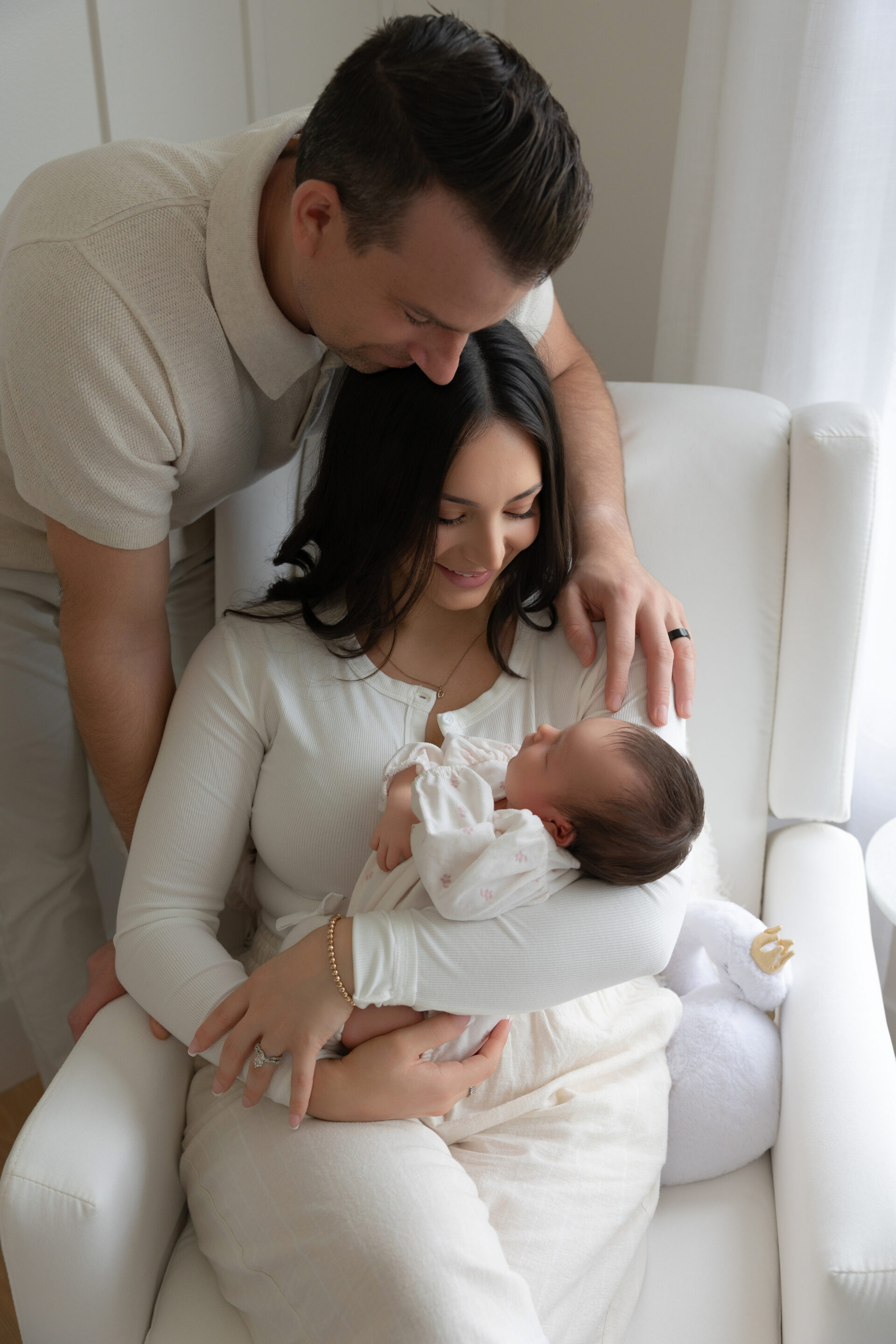 Parents looking lovingly at their newborn baby girl — lifestyle newborn session Northeast Ohio