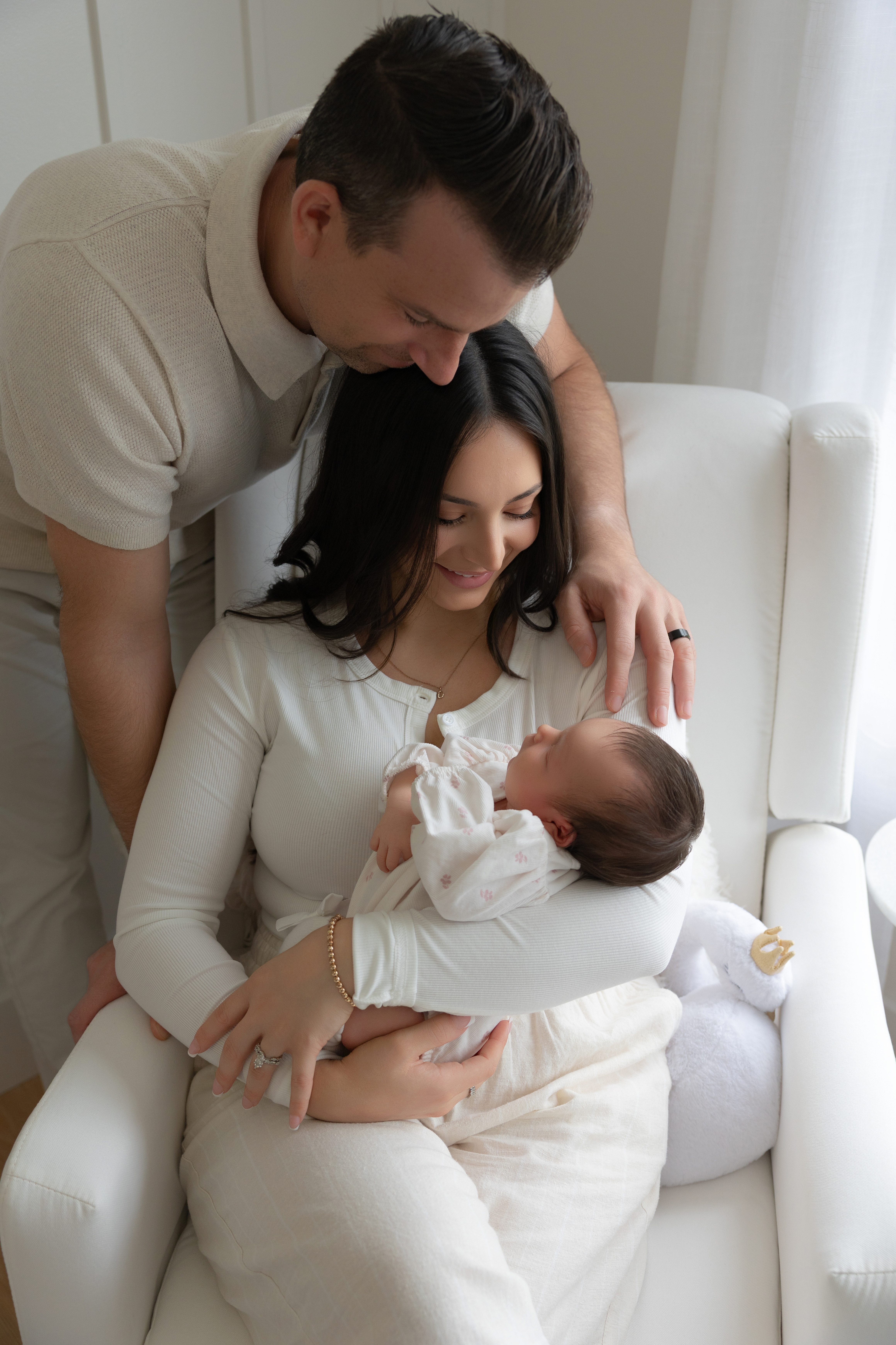 Parents looking lovingly at their newborn baby girl — lifestyle newborn session Northeast Ohio