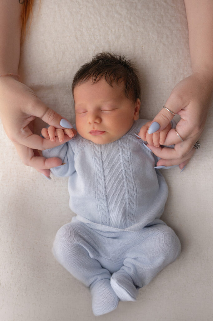safety in newborn and family photography- mom holding her baby's fingers in medina county ohio
